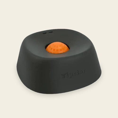 No-spill treat bowl in black with an orange floating ball